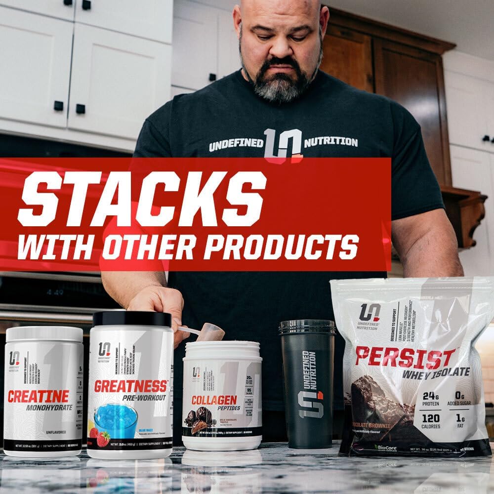 Brian Shaw in a kitchen with Undefined Nutrition products displayed on the counter.