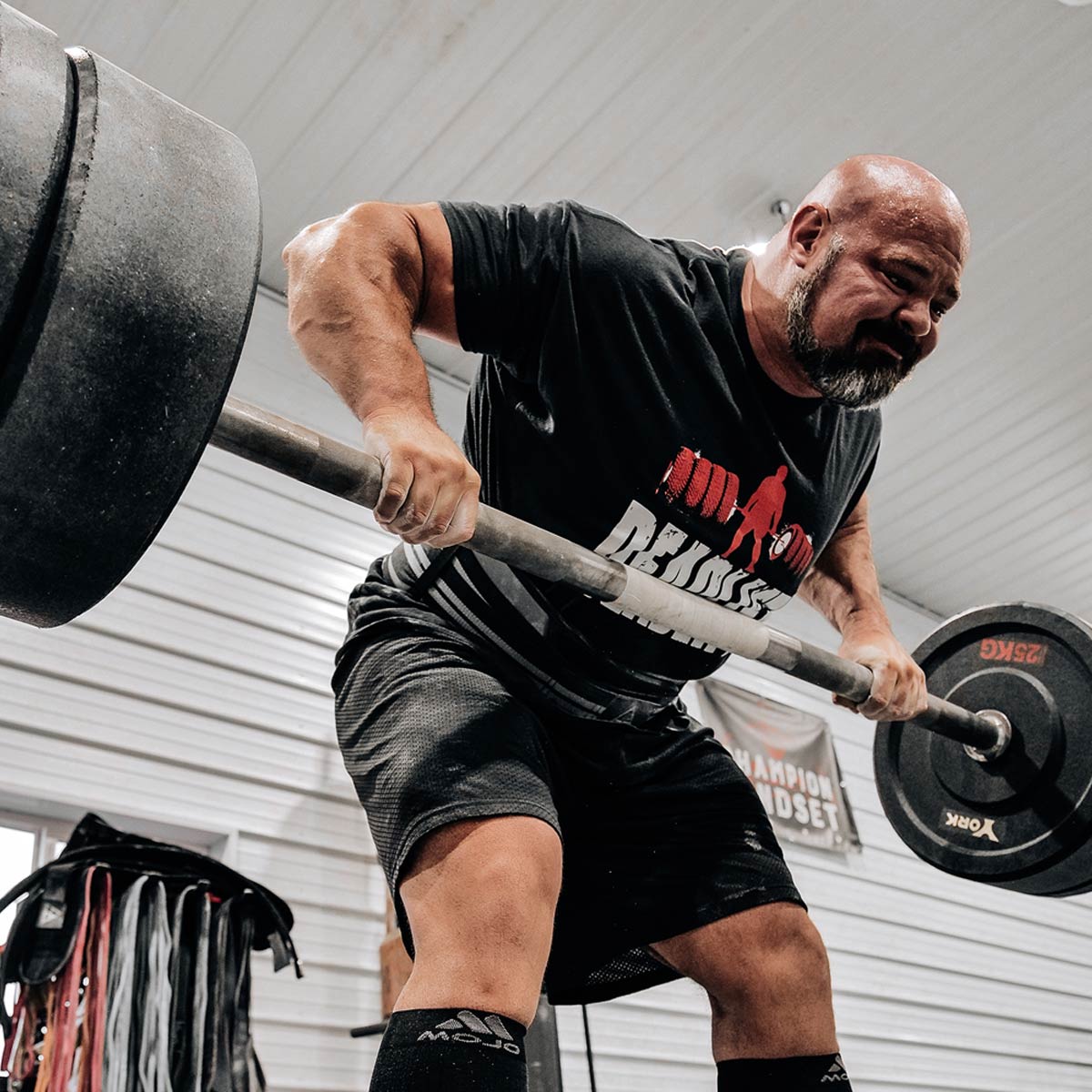 Brian Shaw lifting a barbell in a gym setting