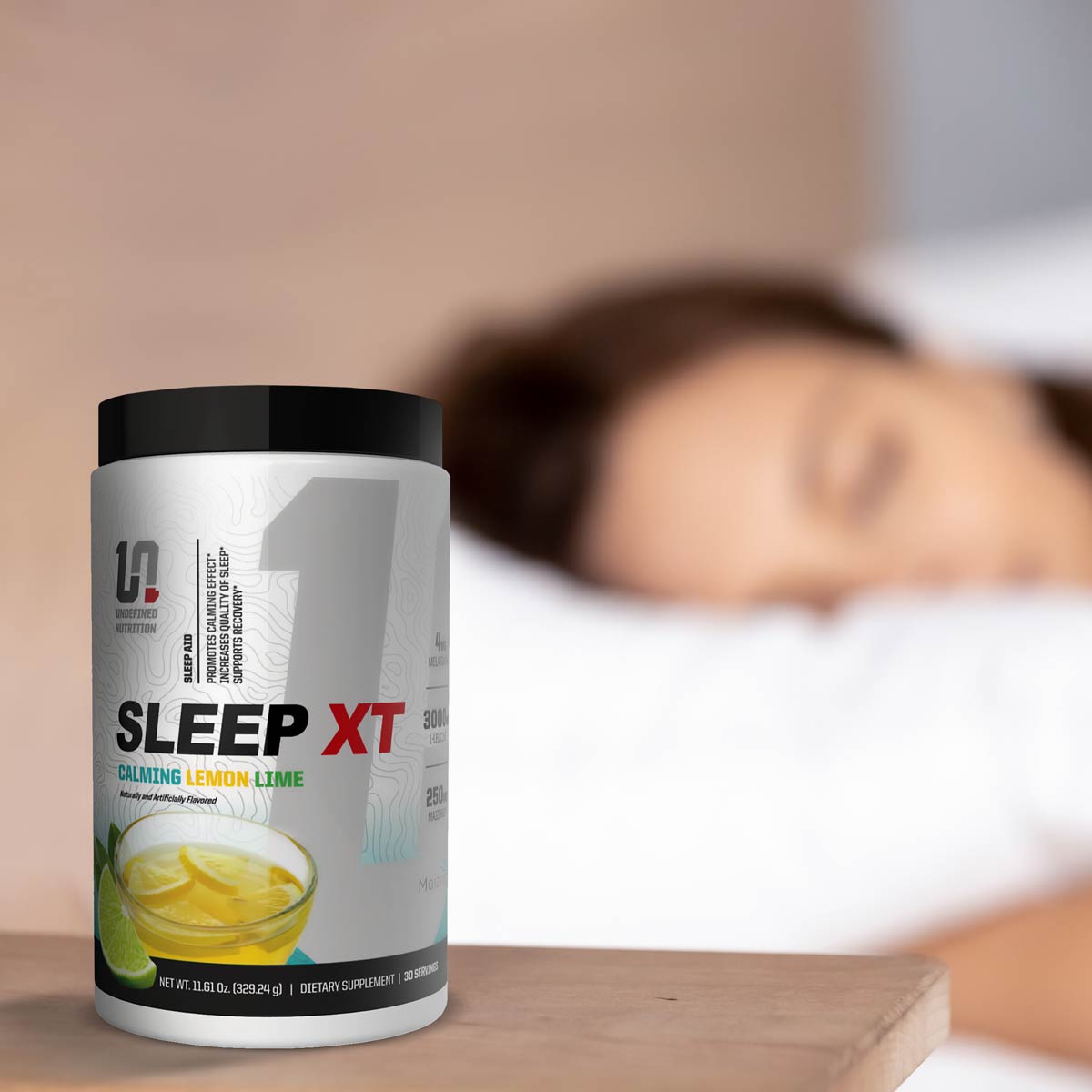 Sleep XT supplement container on a table with a blurred person in bed in the background