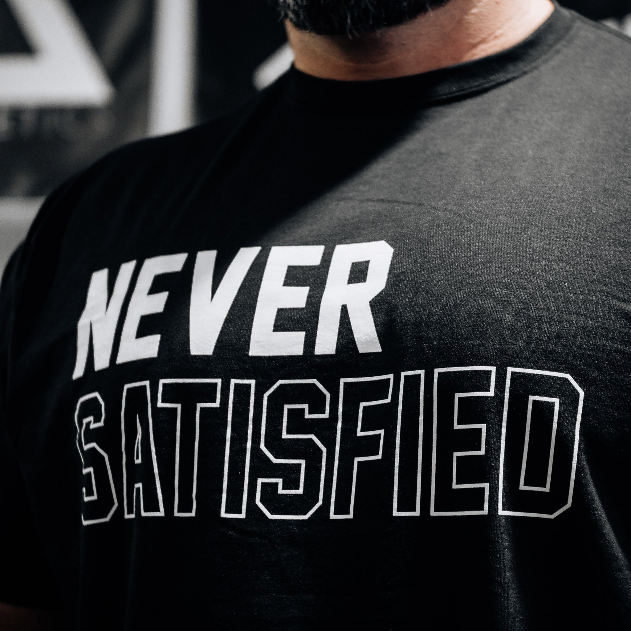 NEVER SATISFIED T-SHIRT - ALL SALES FINAL