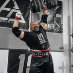 Brian Shaw lifting weights in a gym setting with 'Undefined Nutrition' branding.