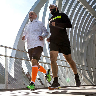 Two men running on a modern architectural bridge