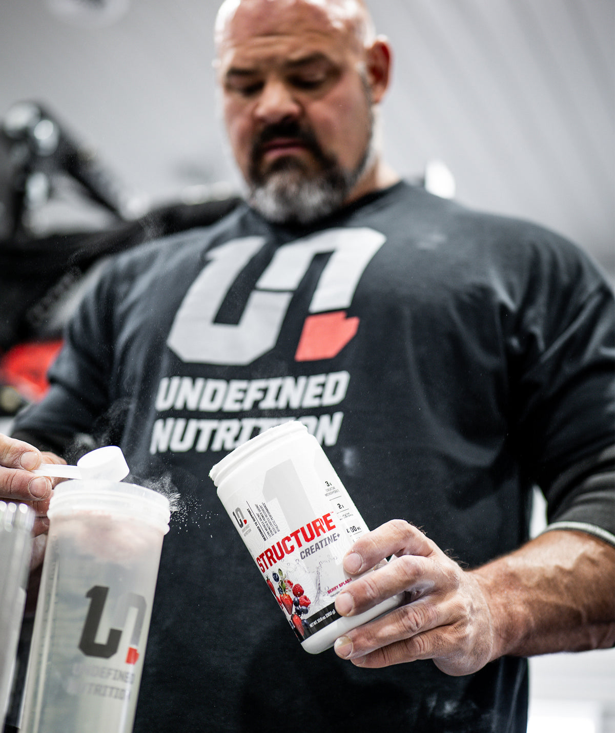 Brian Shaw holding a container of Undefined Nutrition Structure Creatine